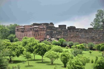 Ranthambore Fort surrounded by lush greenery during the monsoon season.